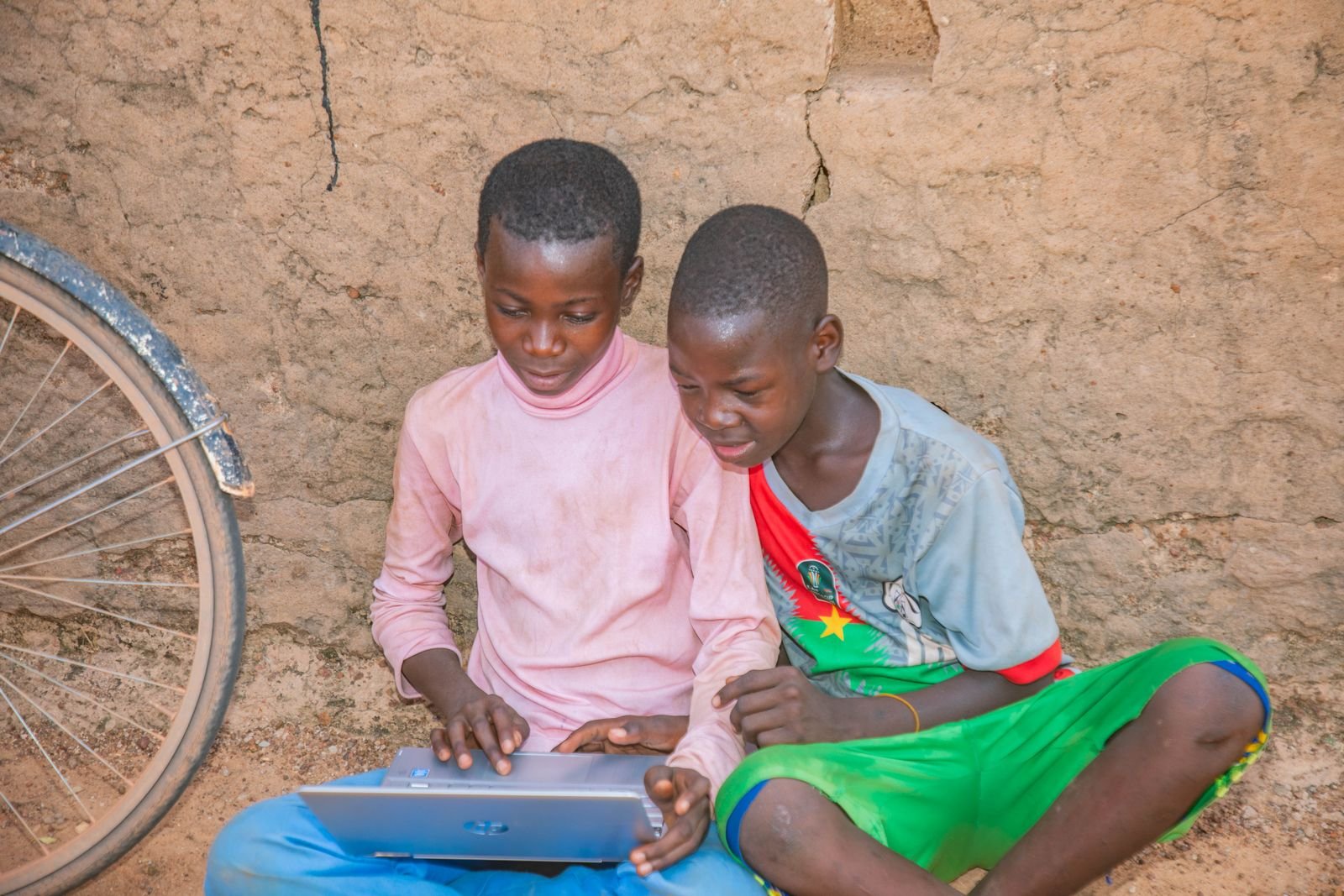 Two boys learning together on a laptop